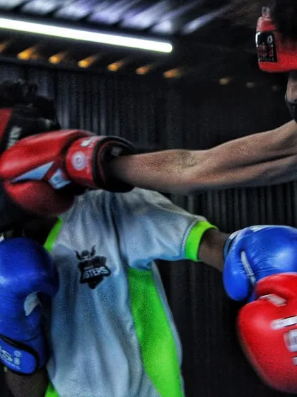 You will get hit. Here, two of our young boxers are in a controlled sparring session, learning to trade punches and think under pressure. This is how you build resilience.