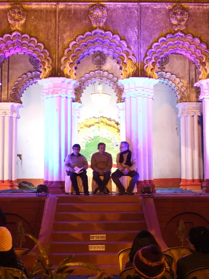 The 'Thakurdalan' (altar space) of a heritage house temporarily converted into a stage for a community event, showcasing the flexibility of traditional spaces.