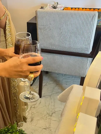 Guests toasting with glasses of red wine. We offer a full bar service, including a selection of wines and beers.
