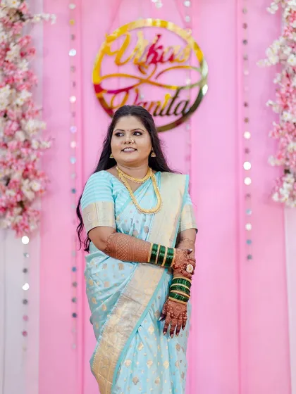 A beautiful candid shot of the client during her engagement ceremony. Her makeup gives her a natural glow, and her hair is styled in soft waves, creating a look that is both elegant and modern.