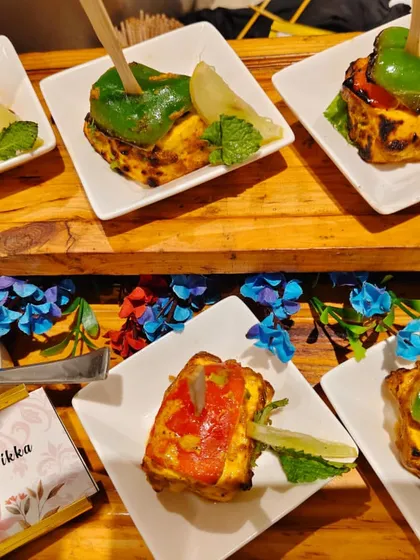 Another look at the Stuffed Paneer Tikka, individually plated and served with a fresh mint dip. This is a popular vegetarian appetizer for weddings and parties.