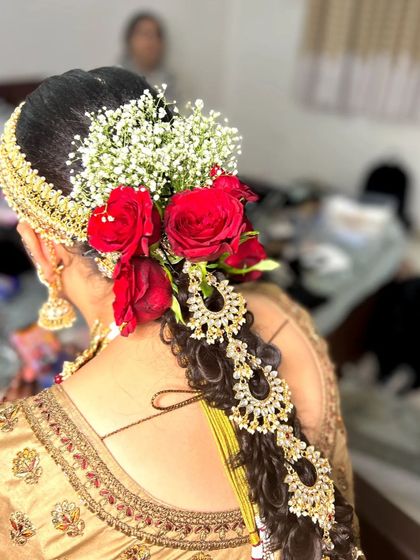 A side angle of the floral bridal braid, showing how the flowers and accessories are carefully placed.