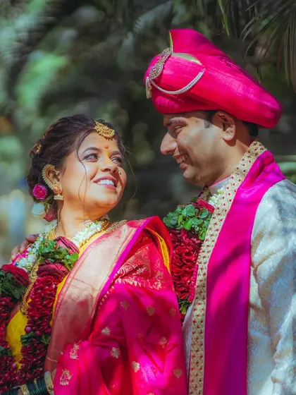 The beautiful, vibrant colors of a traditional Maharashtrian wedding. Here, Pratiksha and Nitesh share a sweet glance, surrounded by lush greenery. I love capturing the unique cultural details and bright emotions of every ceremony.
