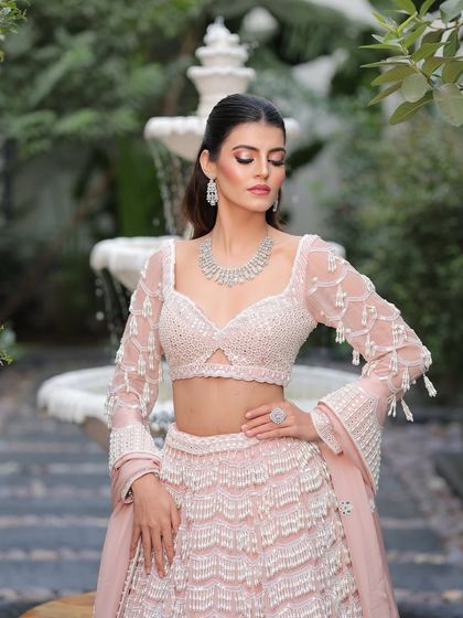 Another beautiful shot showcasing the flawless makeup and the intricate details of her outfit.