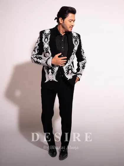 A full-body look at the black embroidered blazer, showing how it creates a sharp, cohesive silhouette that is both timeless and modern.