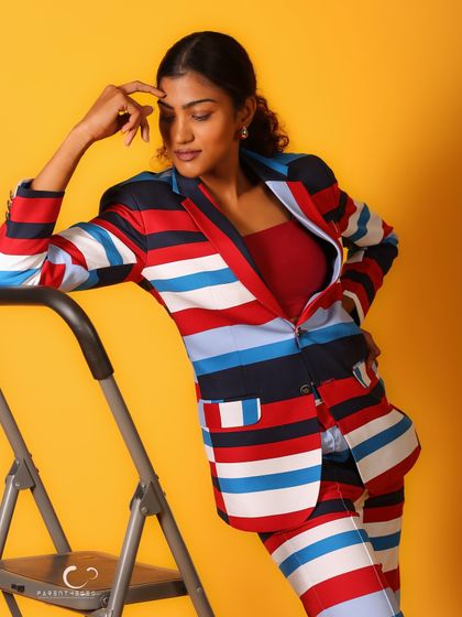 Leaning against the ladder creates an interesting diagonal line in the composition. Her thoughtful expression adds a layer of narrative.