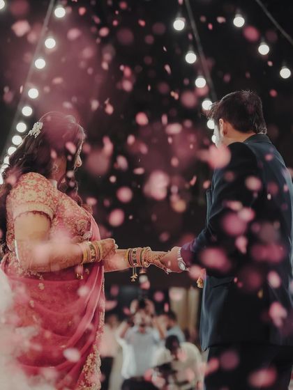 A romantic kiss under a shower of petals. We love creating these fairytale moments for our couples during their reception, making their first dance truly unforgettable.