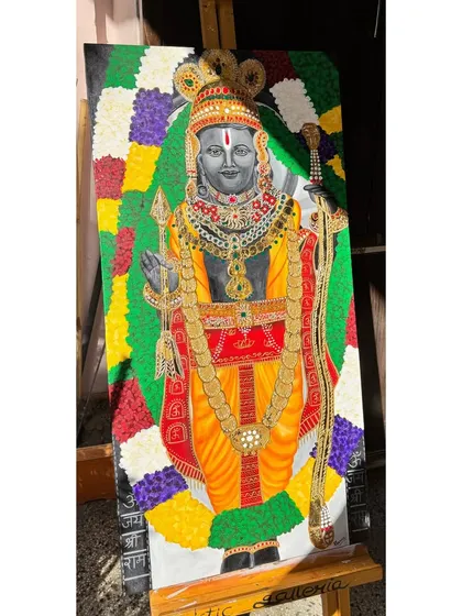 The completed Ram Lalla painting on its easel. This acrylic on canvas artwork features intricate details on the jewelry and a colorful floral background.