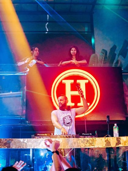 On the mic at Hoot, with the crowd's hands in the air. This is the Saturday ritual.