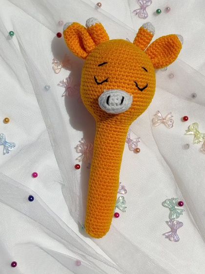 This sleeping giraffe rattle is soft, squishy, and features embroidered eyes, making it completely safe for babies.
