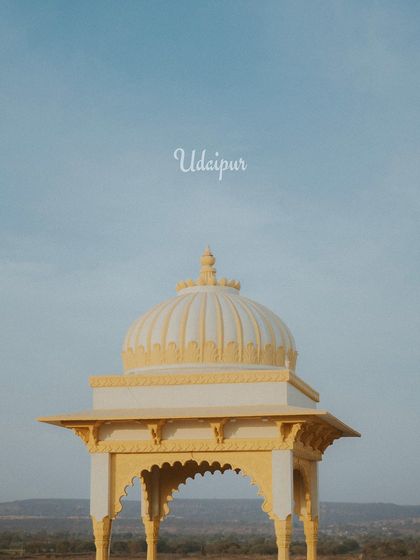 An atmospheric shot of a palace dome against the sky, setting the scene for a royal destination wedding.