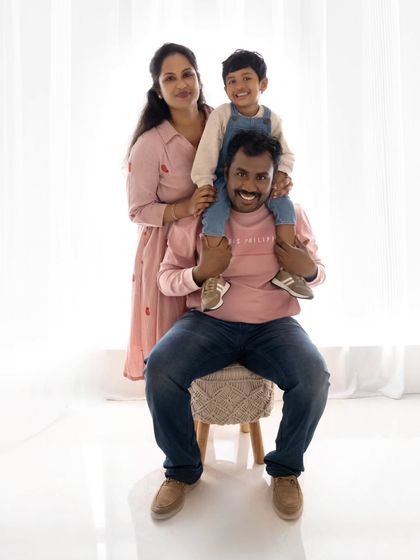 A playful "piggyback" style pose with the son on his father's shoulders.