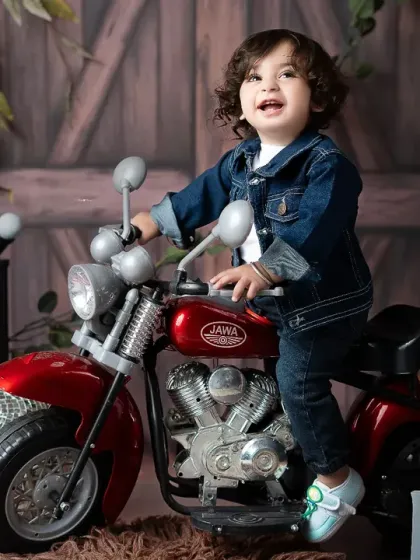Meet the little rockstar! This fun and imaginative toddler photoshoot shows off your child's budding personality with a cool motorcycle prop and a denim-on-denim look, creating portraits that are as unique as they are.