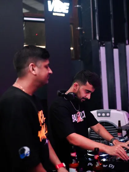 Working alongside DJ Sid at the console.