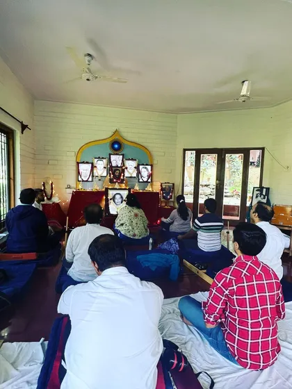 A group of gurubhais meditating together. The shared silence and focus create a powerful vortex of peace that benefits everyone present.
