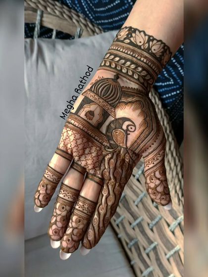 A semi-bridal design featuring a peacock in a jharokha, combining architectural and natural elements for a unique look.