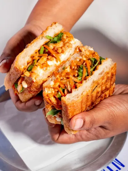 This handheld shot shows the generous size and satisfying filling of the pulled pork sandwich, making it a great value proposition for your customers.