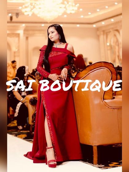 A client looking like a movie star in this stunning red off-shoulder gown with a thigh-high slit and a dramatic trail.