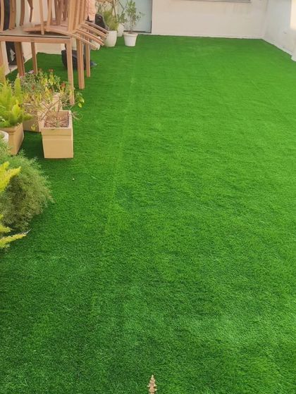 A rooftop terrace covered in artificial grass. It's a simple way to make a concrete rooftop feel softer and more inviting.