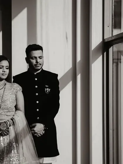 The black and white version of the dramatic window portrait. Removing the color emphasizes the play of light and shadow, giving the image of Shweta and Onkar a classic, cinematic quality.