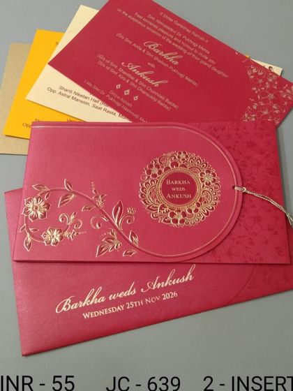 This red invitation features a unique circular flap with a gold foil mandala design. The set includes colorful inserts, making it a vibrant and affordable option.