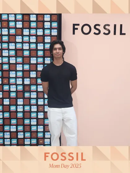 A guest poses against the branded Fossil backdrop. Every photo becomes a piece of marketing material, carrying the event's branding wherever it's shared.