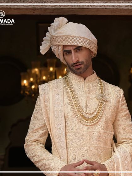 A detailed close-up of a groom's attire from the Shauhar collection. The focus is on the layered pearl mala and the delicate embroidery on the collar and chest, showcasing the precision of my handwork.