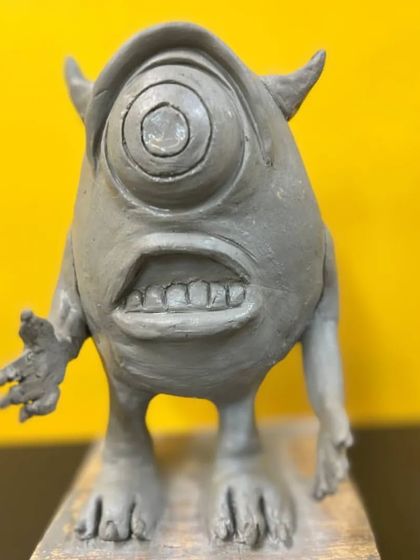 A close-up of a Mike Wazowski sculpture in progress. Notice the attention to detail in the single large eye, the teeth, and the posture, all key elements in bringing a character to life.