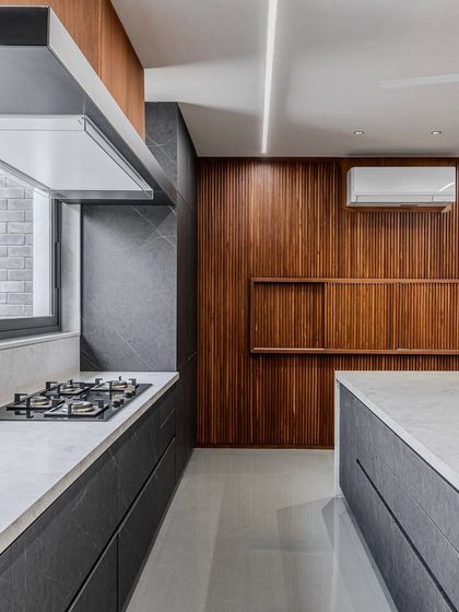 This angle highlights the custom wood paneling that conceals a utility space, demonstrating how we can integrate functional needs into a high-design aesthetic.