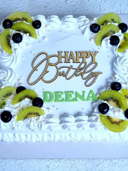 A top-down view of the Tres Leches cake, showing the arrangement of kiwi and blueberries.