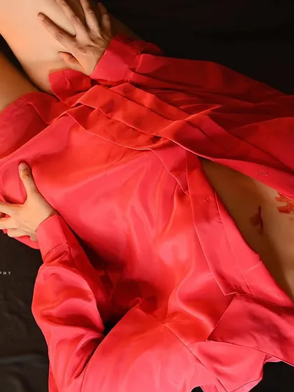 An artistic overhead shot of a model in a red shirt, with lipstick marks adding a conceptual element. This is a bold, editorial-style image.