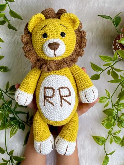 A royal lion plushie, personalized with the initials "RR" on his belly. This majestic friend is ready to rule the playroom with kindness.