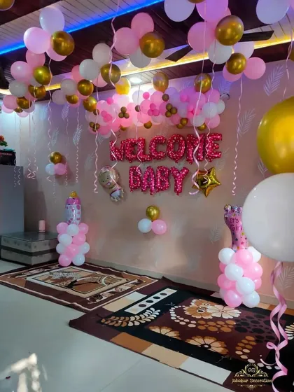 A wider shot of the pink-themed welcome home room setup.