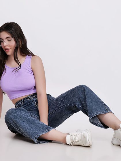 A seated floor pose showing a casual and comfortable look, ideal for loungewear or everyday fashion collections.