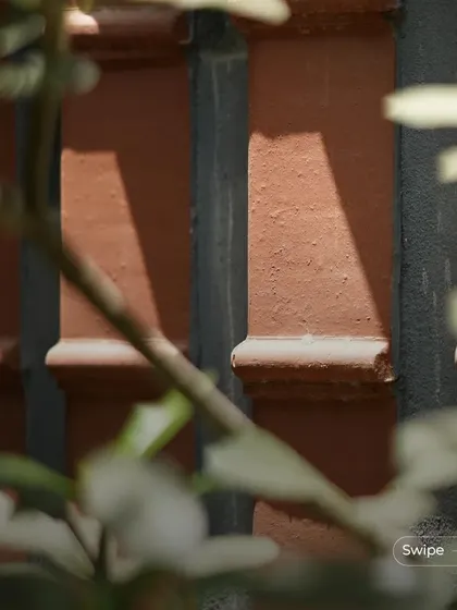 A close-up of the textured terracotta columns, a recurring design element that provides both structural support and aesthetic beauty.