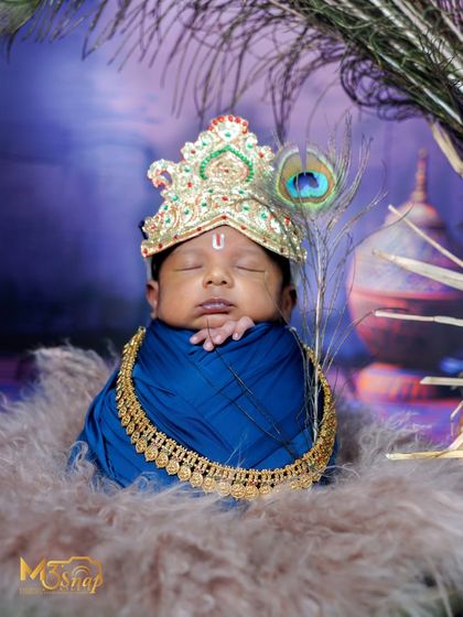 A different perspective of the baby Krishna setup, showing the soft, cloud-like fur he is resting on.