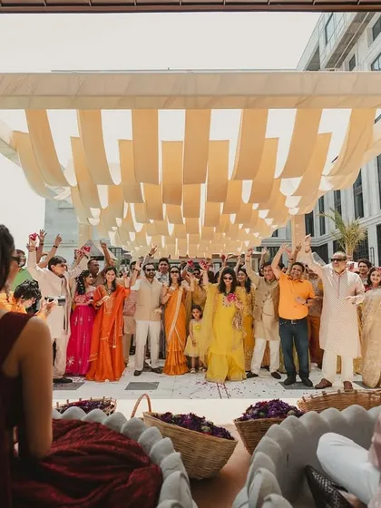 The view from the stage, looking out at a sea of happy faces as guests prepare to shower the couple with flowers.