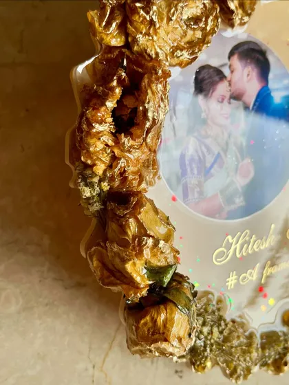 A detailed shot of the 3D preserved golden roses on a custom photo frame. The texture and depth are truly stunning, making the flowers look like they are still fresh.