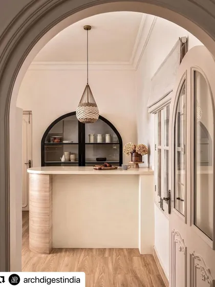 As seen from the arched doorway, the bar area becomes an inviting destination within the home. This view shows how I use architectural framing to create distinct yet connected spaces.