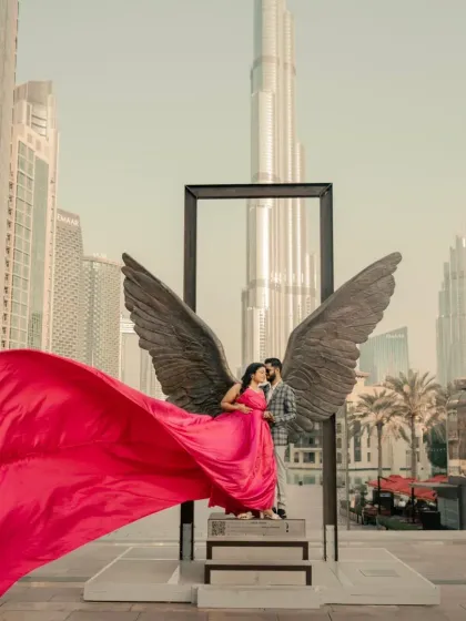 Taking romance international with a pre-wedding shoot in Dubai. My vibrant rani pink satin gown with its flowing trail stands out beautifully against the iconic city skyline. We can ship your dream gown anywhere.