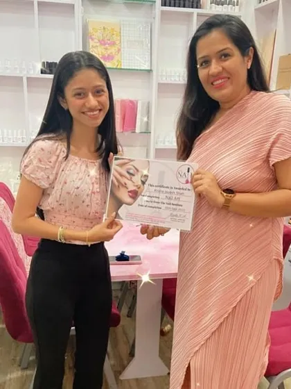 A proud moment for our student Krisha as she receives her certificate after completing her nail art course with us.
