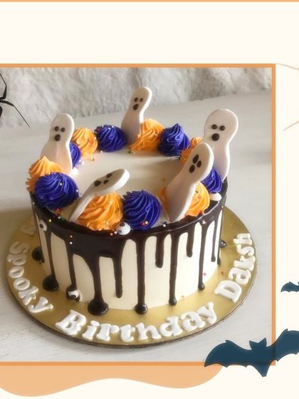 A spooky birthday cake with a chocolate drip and fondant ghosts popping out of the top.