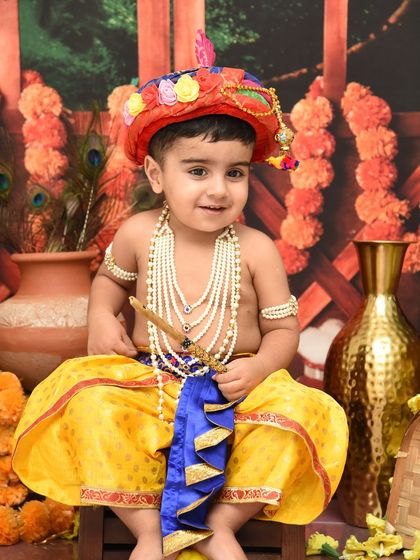 A beautiful portrait of a slightly older boy dressed as Krishna. The colorful turban and pearl necklaces complete this classic and beloved look.
