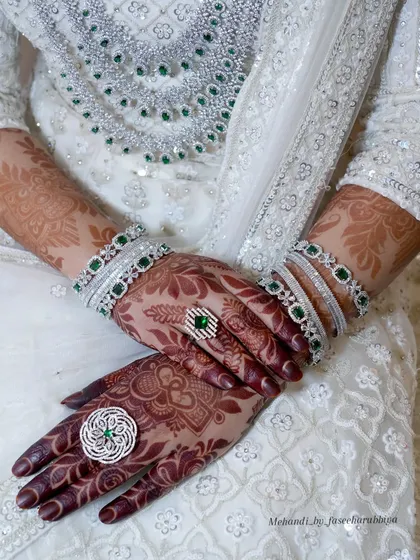 A posed shot highlighting the beautiful henna stain and the bride's elegant rings and bangles.