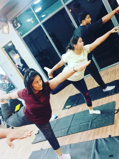 Here, a student practices Natarajasana (Dancer's Pose), a beautiful and challenging pose that improves balance and opens the shoulders and chest.