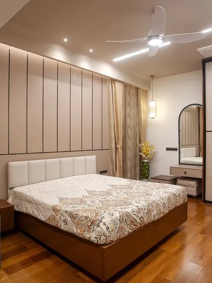 I designed this bedroom for my client’s elderly parents, focusing on comfort and accessibility. The soft color palette, upholstered headboard, and warm wooden flooring create a restful and safe environment.