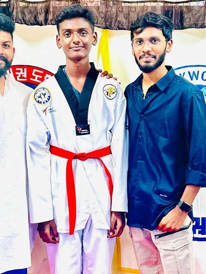 A student celebrates his new red belt.