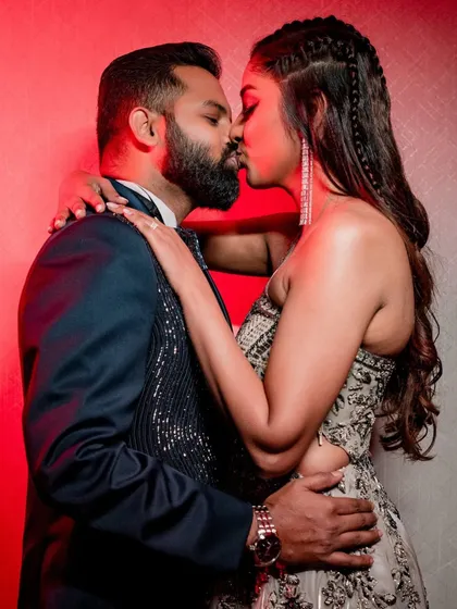 An intimate and passionate kiss, captured with dramatic lighting that enhances the romance of the moment.