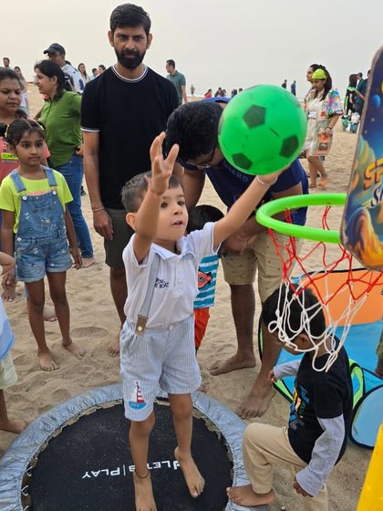 Soaring high for a slam dunk. Our beach trampoline and basketball hoop setup is a huge hit, combining jumping and coordination in one exciting activity.