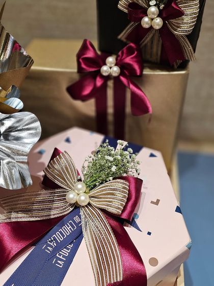 A close-up of the bow details from the Shoppers Stop and Axis Bank hampers. I layered different ribbons and added pearl accents to create a look that is both corporate and chic. The custom branded ribbon adds another layer of personalization.